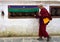 Monk walking prayer wheels