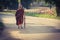 Monk walks down the street to the temple
