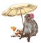 Monkey sitting on the beach under a beach umbrella with a tropical flower on his head