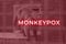 Monkeypox virus. Red background. Outbreak concept. Virus transmitted to humans from animals. Monkeys may harbor the