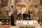 The monks after finishing the prayer leave the main altar of the Church of the Annunciation in the Nazareth city in northern