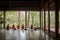 monks in meditation hall, with view of the garden and birds singing