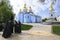Monks standing near the church, St. Michael Golden-Domed Monastery on a background. April 27, 2018. Kiev, Ukraine