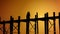 Monks walk through the ancient wooden bridge. Burma, Mandalay