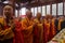 Monks wearing robes and praying