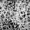 Monochromatic abstract seamless pattern of chaotic messy irregular intertwined threads ropes twines fibers Tangled mesh