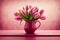 monochromatic hot pink colored tulips in a pot on a wooden table over a pink rustic background. Bouquet of pink tulips on pink