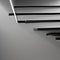 A monochromatic image of light and shadow on a staircase, creating an abstract play of depth and contrast3, Generative AI