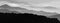 Monochromatic scene of foggy landscape of mountains layers. Misty mountains with fog in black and white