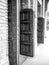 Monochrome black and white shot of open antique wooden doors in a church. Solid oak, particle walls