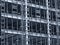 Monochrome blue tinted view of a large building development under construction with steel framework and girders