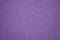 Monochrome dark purple surface with small silvery blotches