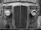 monochrome front view of an old abandoned rusty 1940s truck