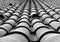 Monochrome full frame diminishing perspective view of an old roof with curved tiles in lines with ventilation slots