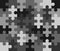 Monochrome gray puzzle pattern. Spare parts, particles, blocks are connected in single common connection. Vector