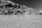 Monochrome image of frozen lake and rocky mountains in Spain, Gredos