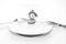 Monochrome image, old pocket watch on white plate, cutlery