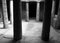 monochrome image of an underground chamber at the tombs of the kings in paphos cyprus with old eroded sandstone columns