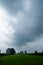 Monochrome Majesty: Stormy Skies over Lush Fields