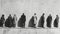 Monochrome painting of people in line, depicting the universal act of waiting. Concept of patience, time passage, common