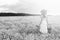 monochrome portrait of young girl in a hat standing in a huge fi