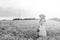 monochrome portrait of young girl in a hat standing in a huge fi