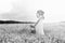 monochrome portrait of young girl in a hat standing in a huge fi