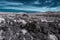 Monochrome rocky landscape with blue sky and white clouds