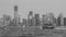 Monochrome shot of New York City with the boats on the water, USA