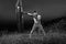 Monochrome shots of a male boxer training with a punching bag ou