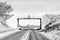 Monochrome view of railway bridge frames mountain scene near Win