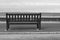Monochrome Wooden Seaside Bench at a Coastal Location
