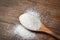 Monosodium glutamate on wooden spoon on rustic wood background / MSG