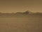 Monotone image of lonely natural sand dune curved ridge with soft shadow on vast empty dried desert landscape