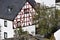 Monreal, Germany - 09 23 2020: The small stone bridge with roses blooming at a half-timbered house