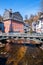 Monschau, Germany. Red house on the Rur river and fortification Haller on the hill