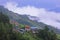 monsoon clouds slowly covering the lush green himalaya mountain foothills and valley in monsoon season