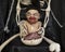 Monster baby with bloody mouth in skeleton`s lap