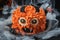 Monster theme cake on the black spooky background. Halloween cake with orange fluffy cream cheese frosting