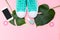 Monstera and pair of mint color canvas. Trendy fashion woman accessories