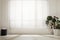 Monstera plant and pouf near large window with blinds in spacious room. Interior design