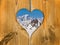 The Mont-Blanc mountain covered with snow viewed through a wooden heart