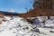 Mont Fuji on a clear winter day from a small stream, in Saiko lake area covered by pristine snow in the five lakes