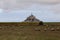Mont Saint Michel Abbey in Normandy region of Northern France and the flock of black-headed Suffolk sheep