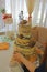 Montage installation of nude wedding cake on stump, pretty cake with cones, grass