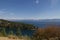 Montana Vista with mountains, water and pines on an outcropping.