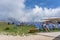Monte Baldo, Italy - August 8, 2019: Tourists hiker rest in deck chair in the morning sun on monte baldo by lake garda