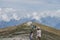 Monte Baldo, Italy - August 8, 2019: Tourists hikers walk on top of monte baldo with heavy fog in the background