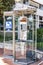 Monte Carlo, Monaco, 10/05/2019: Modern glass telephone box on a city street.