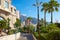 Monte Carlo pedestrian street and garden with tropical vegetation and skyscrapers view in a sunny day in Monte Carlo, Monaco